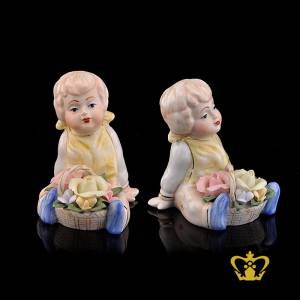 A-Masterpiece-Ceramic-Figurine-of-a-Baby-Doll-seated-along-with-Bunch-of-Colorful-Flowers