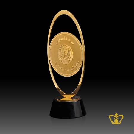 Custom-Made-Gold-Metal-Trophy-with-Intricate-Detailing-stands-on-a-Clear-Round-Black-Crystal-Base